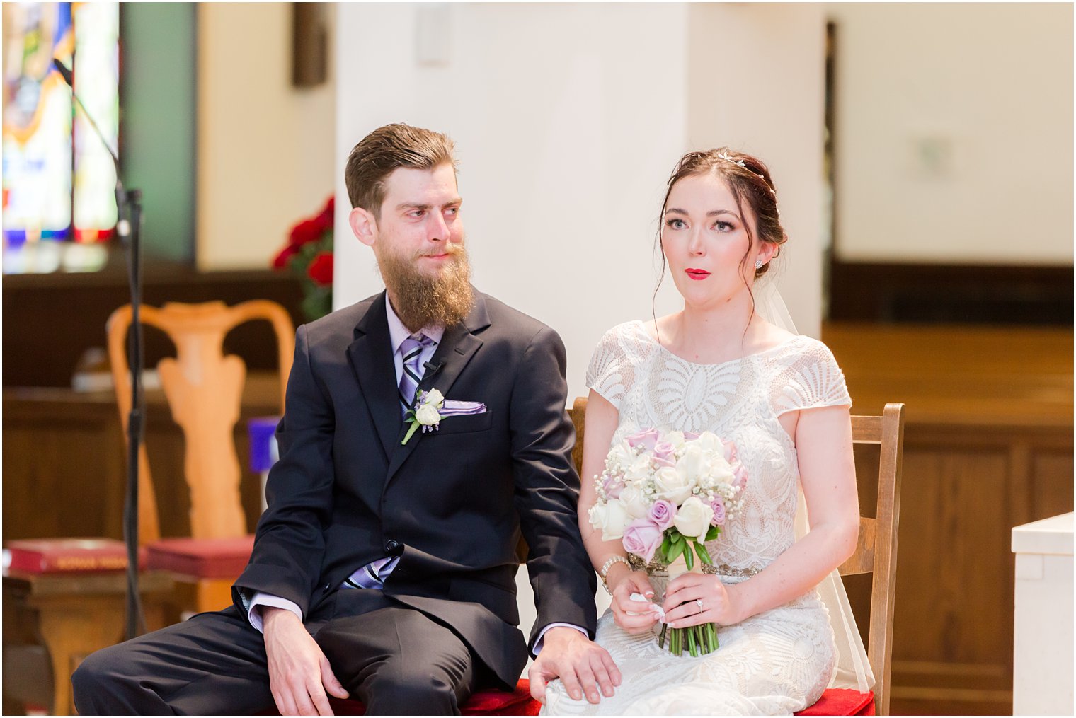 groom looks at bride during traditional church wedding in New Jersey