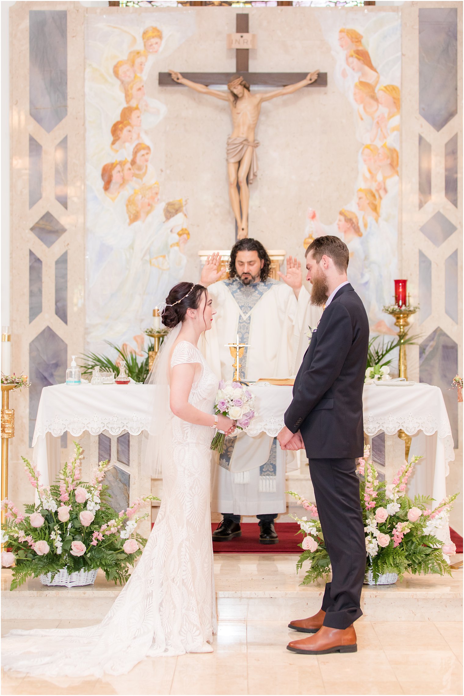 bride and groom stand at alter during traditional church wedding in New Jersey