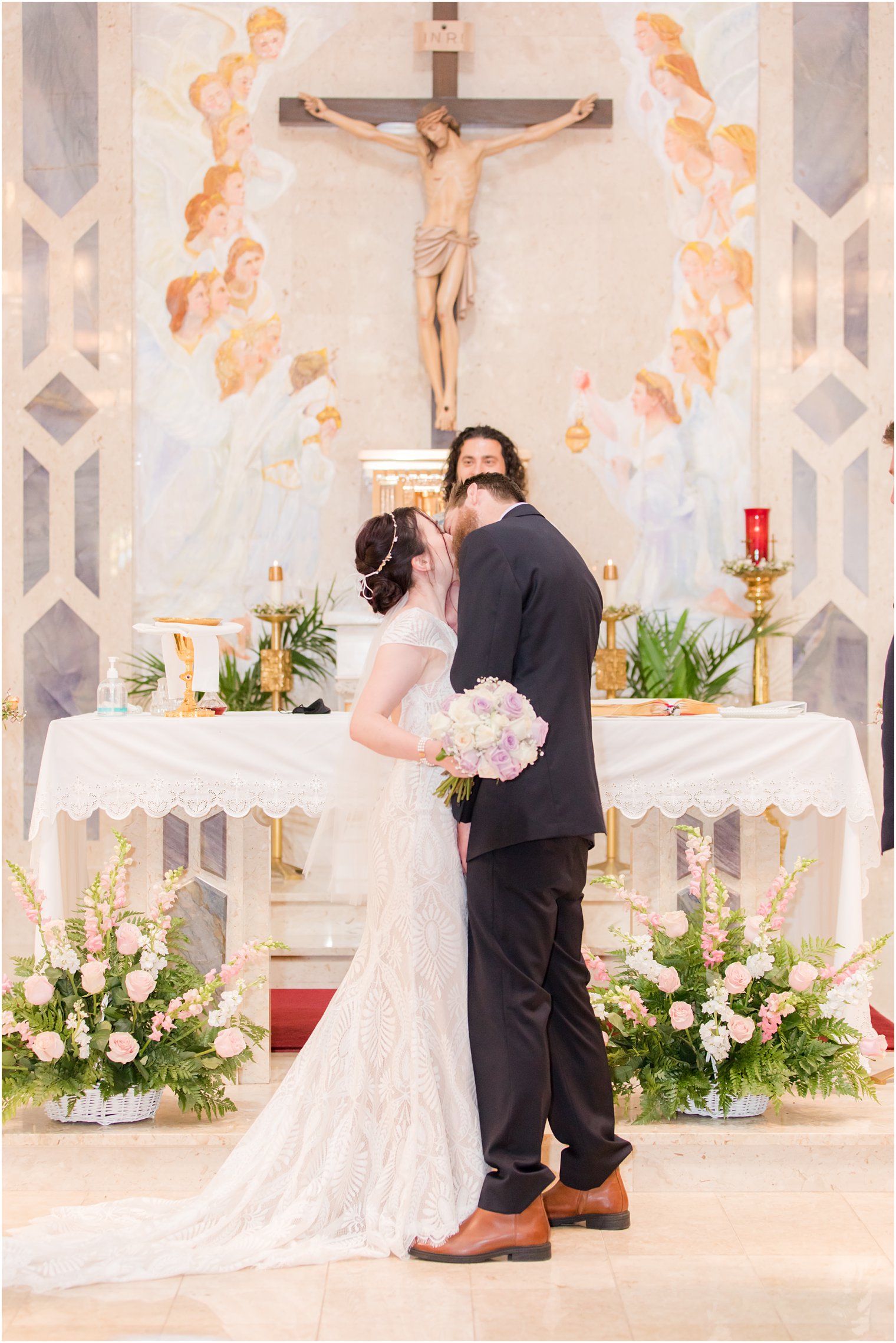 newlyweds kiss during traditional church wedding in New Jersey