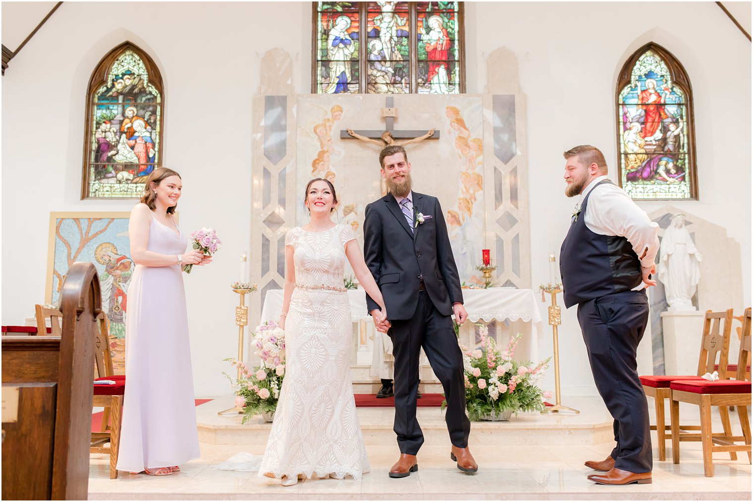 bride and groom face guests after traditional church wedding in New Jersey