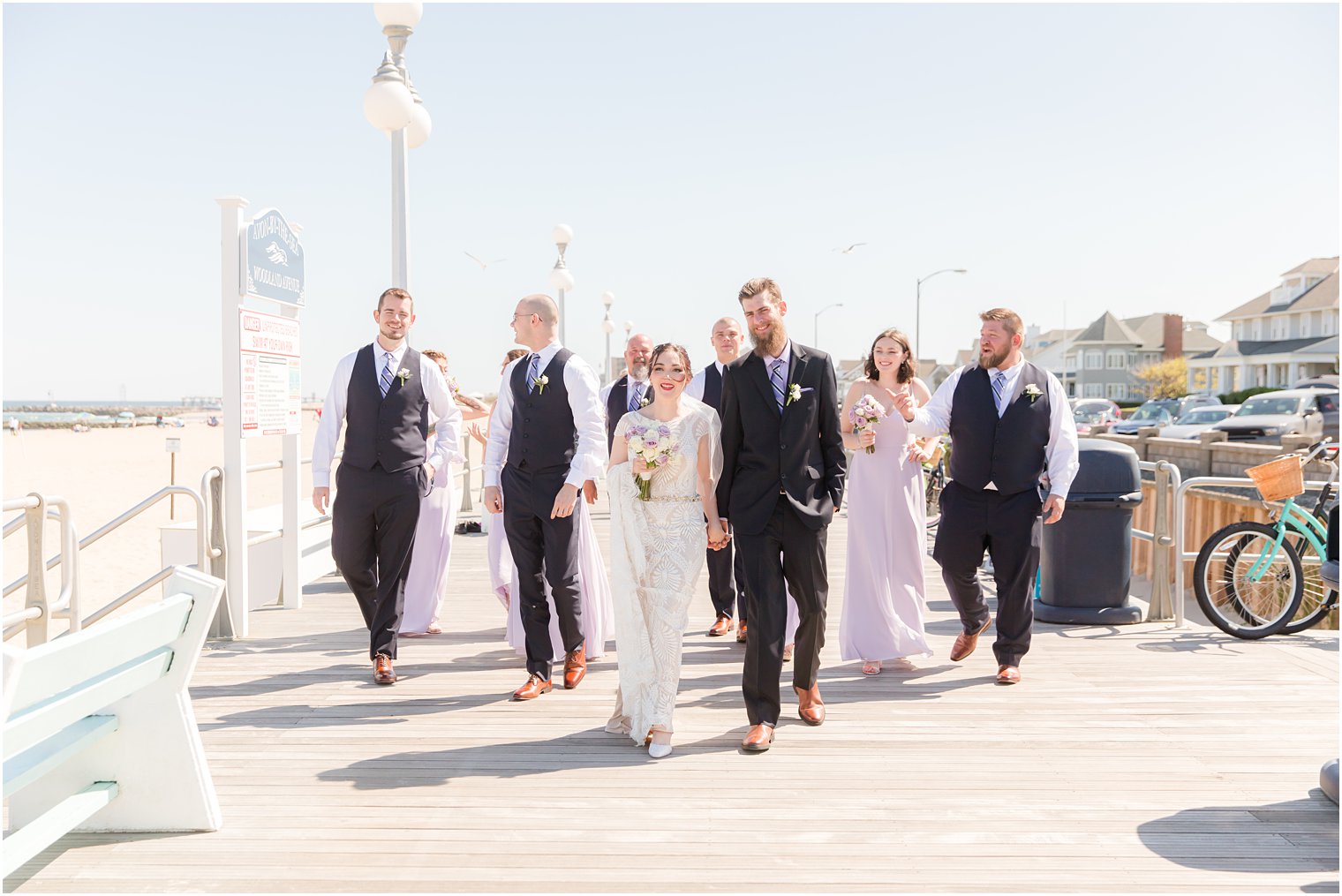 bride and groom walk down boardwalk in Ocean Township NJ