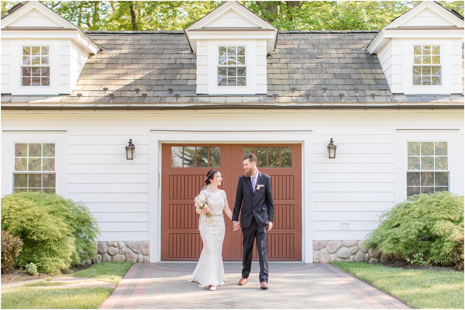 bride and groom walk outside The English Manor