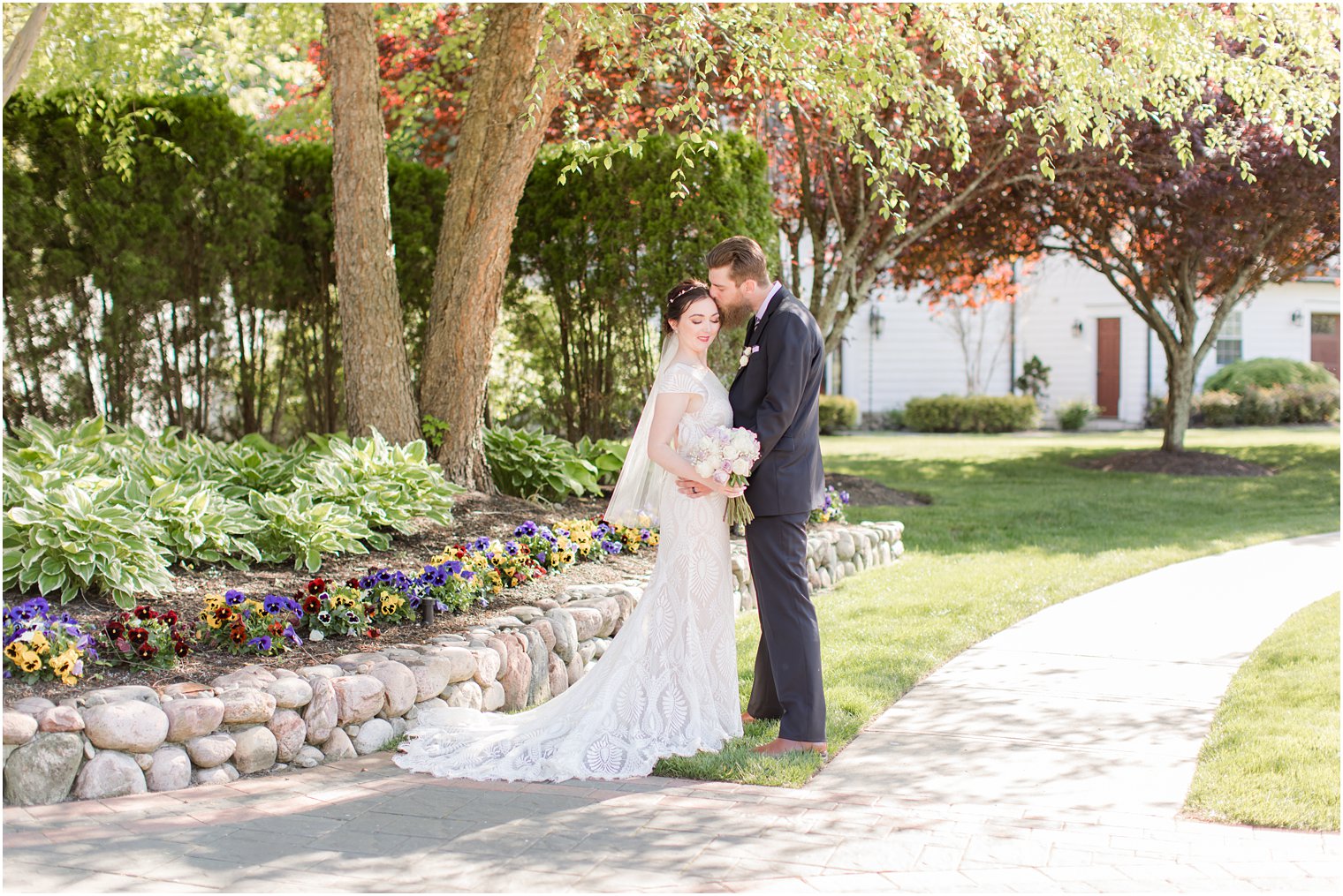 groom kisses bride's forehead during The English Manor wedding photos