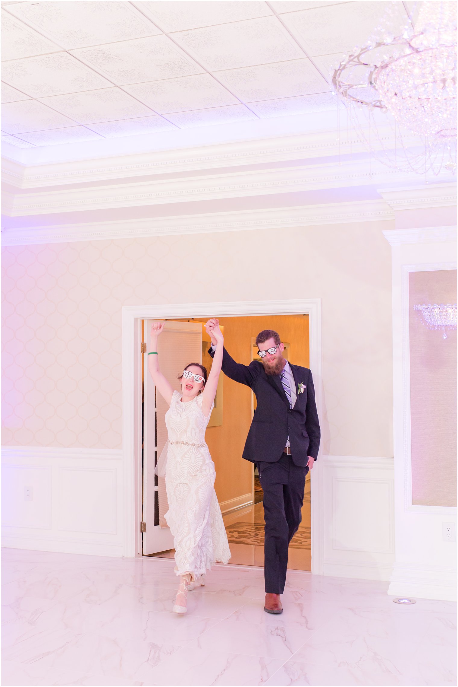 bride and groom enter wedding reception at The English Manor with funny sunglasses