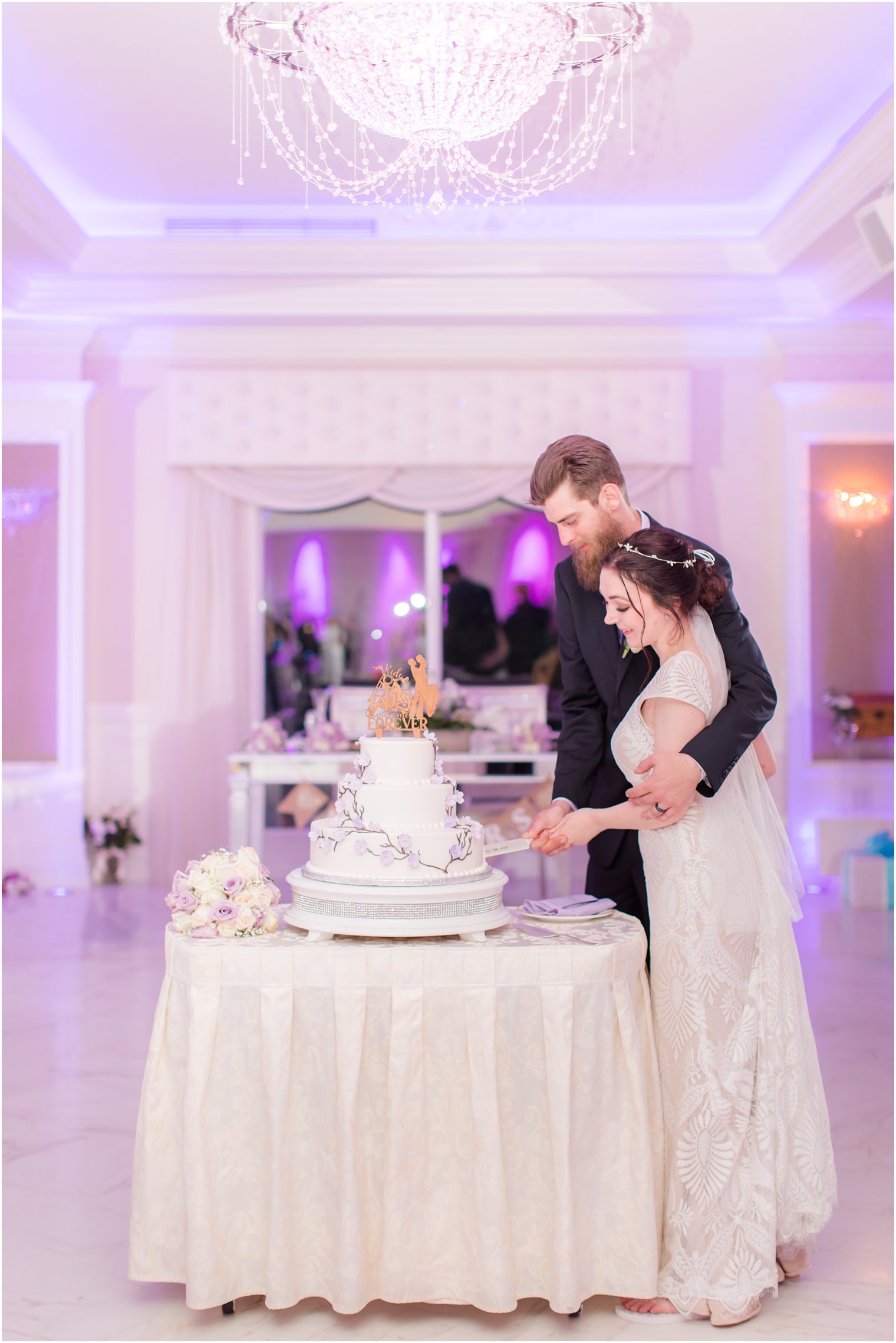 bride and groom cut wedding cake at The English Manor