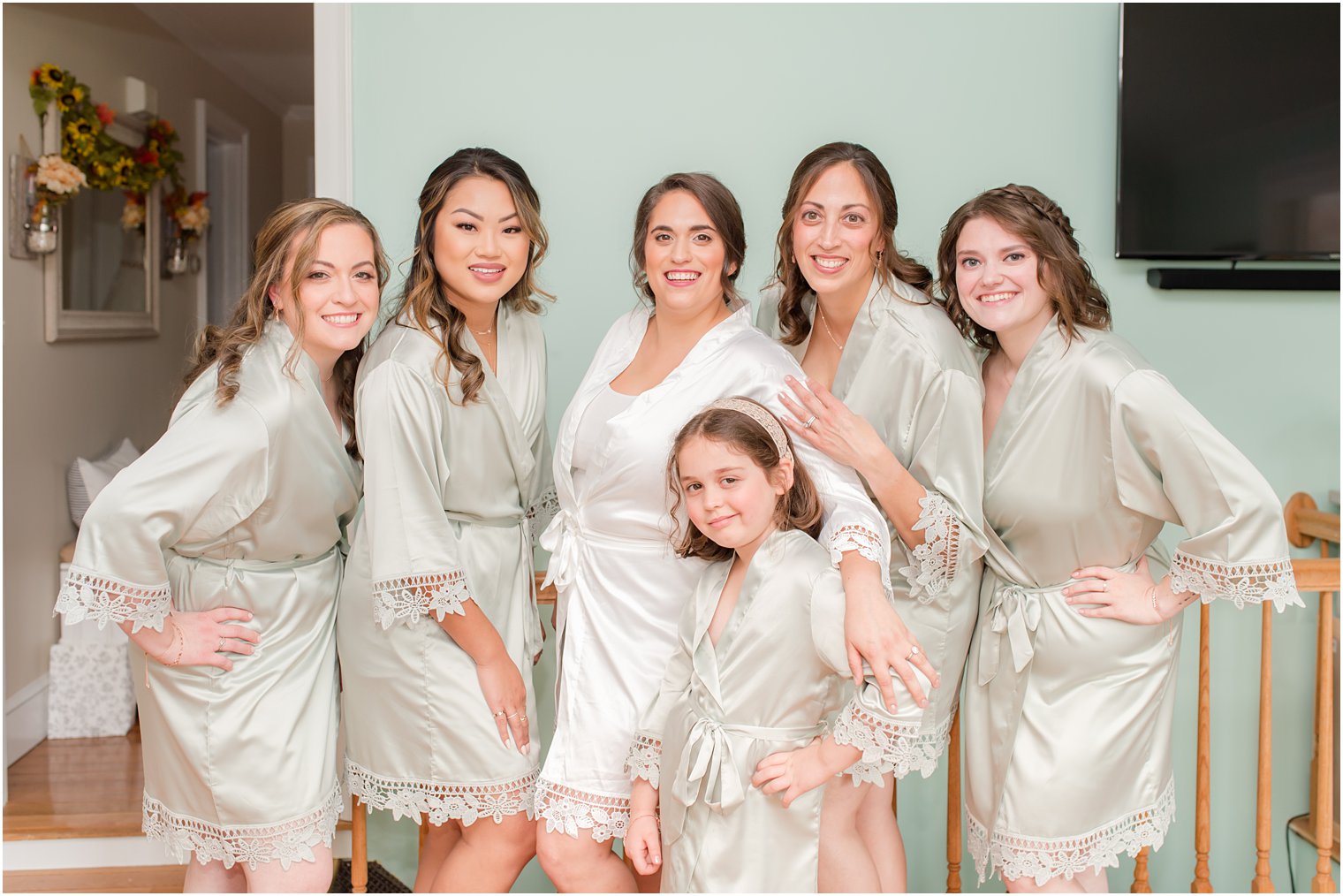 bride poses with bridesmaids in custom green robes