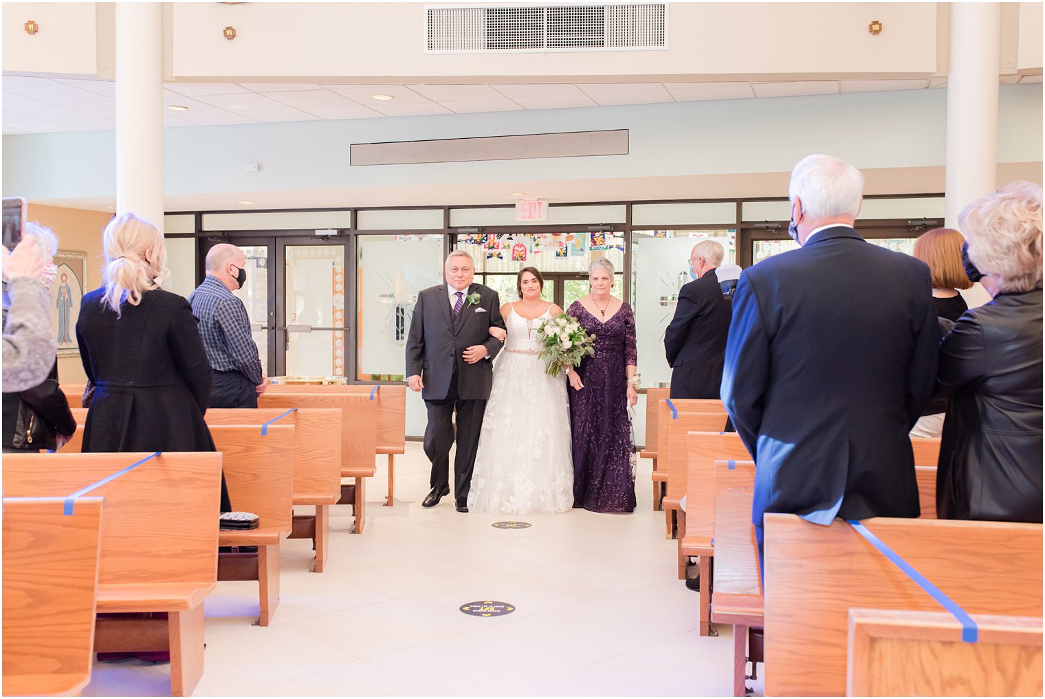 bride enters traditional church wedding in New Jersey with both parents