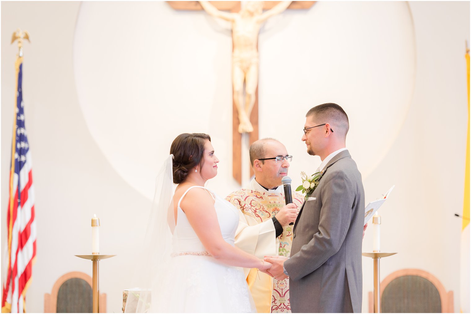 bride and groom exchange vows during traditional church wedding in New Jersey