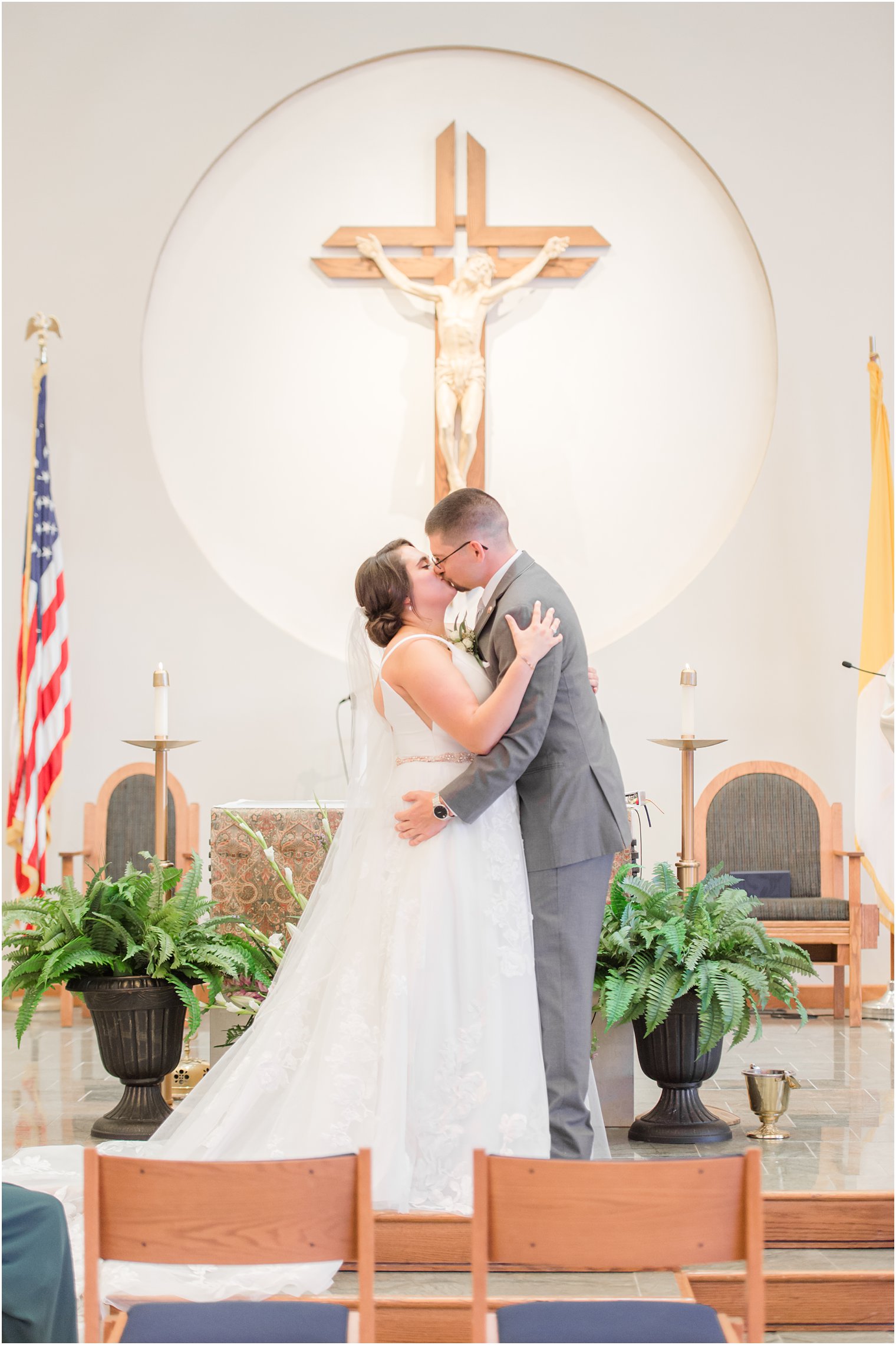 newlyweds kiss after traditional church wedding in New Jersey