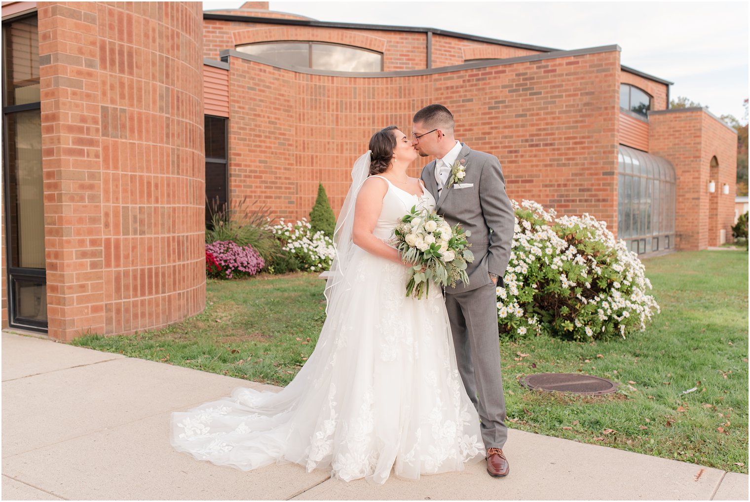 newlyweds kiss during NJ wedding portraits 