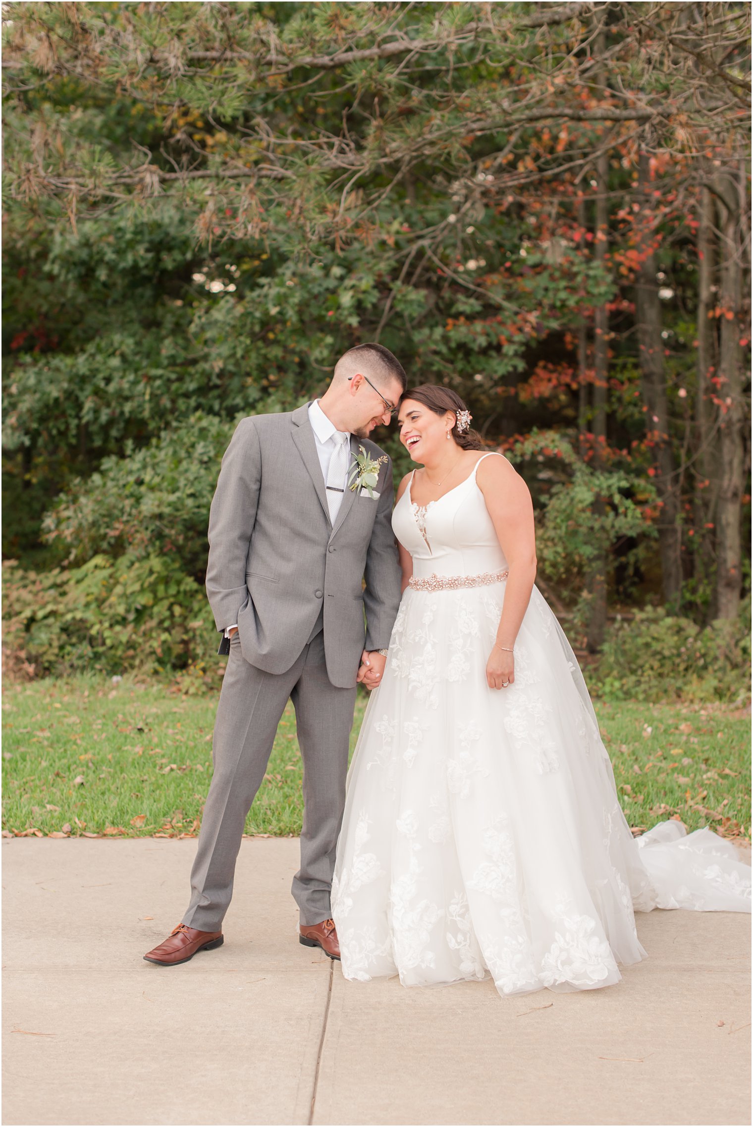bride and groom hold hands walking during NJ wedding photos