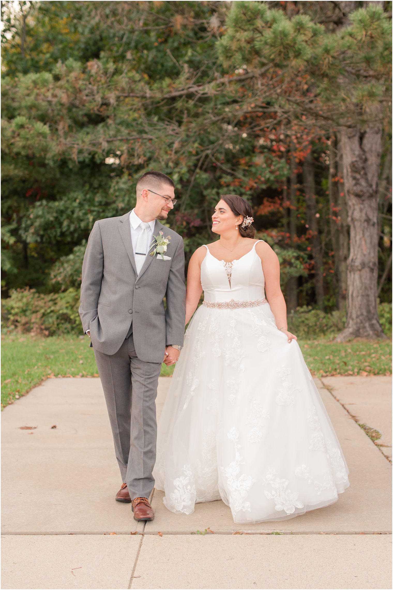 bride and groom hold hands walking in Morristown NJ