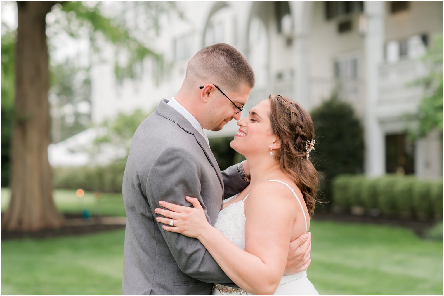 newlyweds hug and touch noses during NJ wedding photos