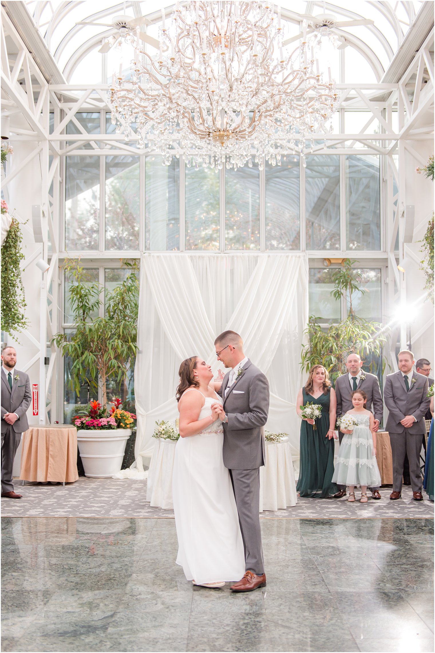 newlyweds dance together in atrium at The Madison Hotel wedding reception