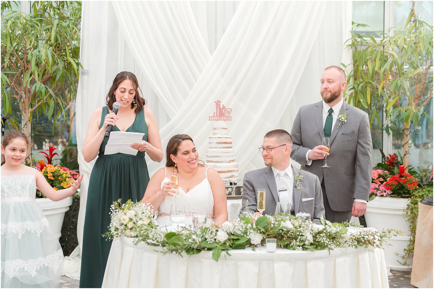 MOH in green gown reads toast during NJ wedding reception