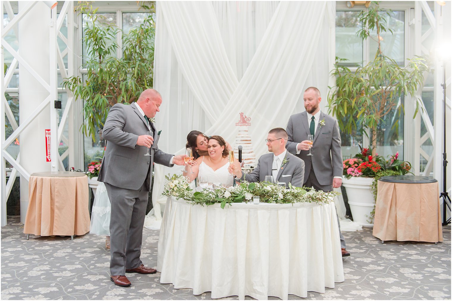 maid of honor gives bride a kiss during reception at The Madison Hotel