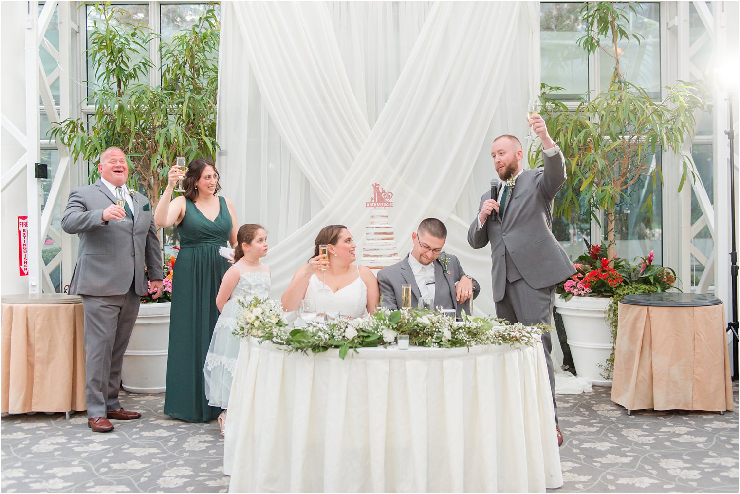 newlyweds toast with best man during NJ wedding reception