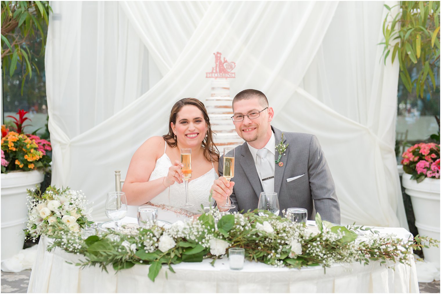 newlyweds toast champagne during NJ wedding reception at The Madison Hotel