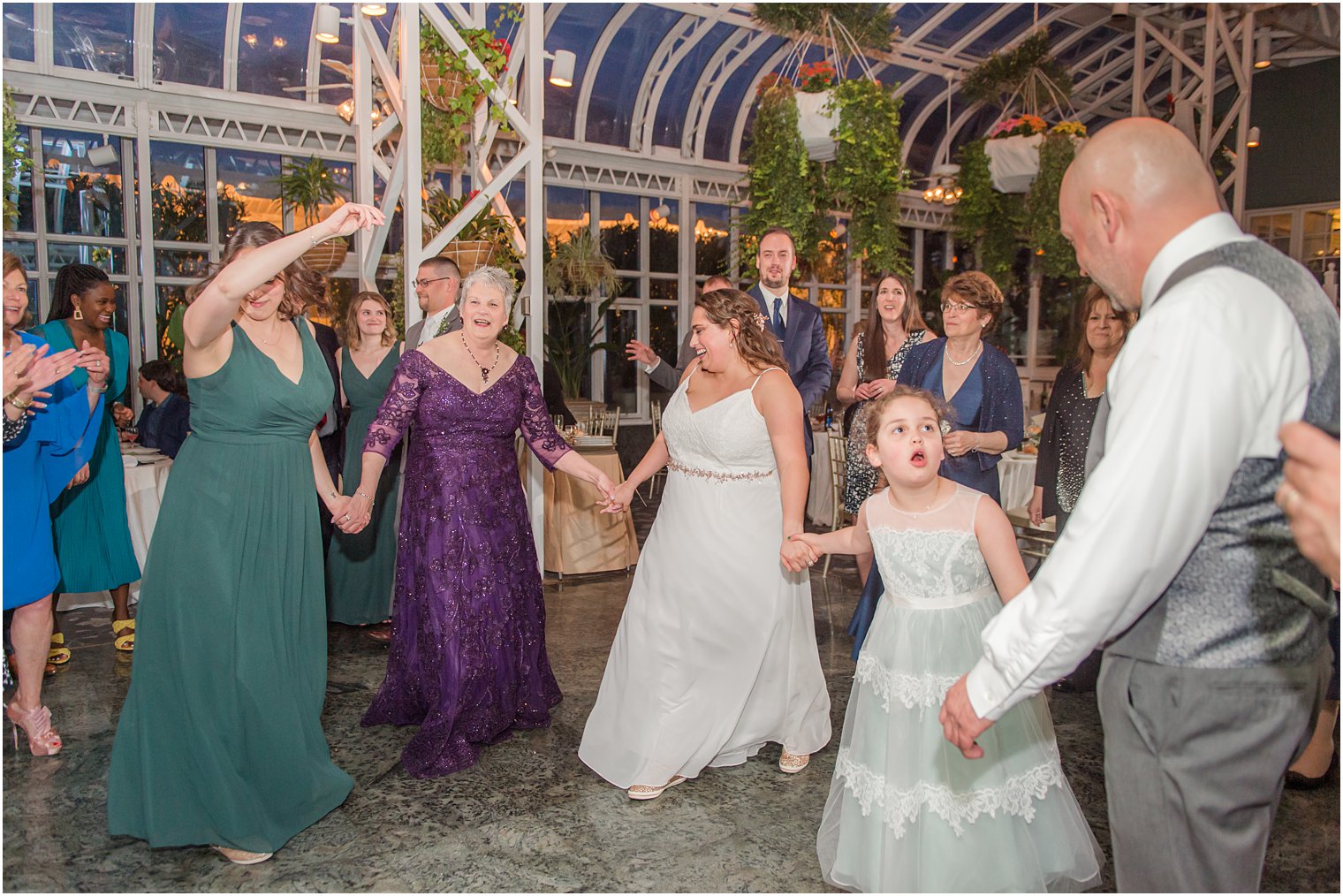 bride and groom dance with mother and bridesmaid