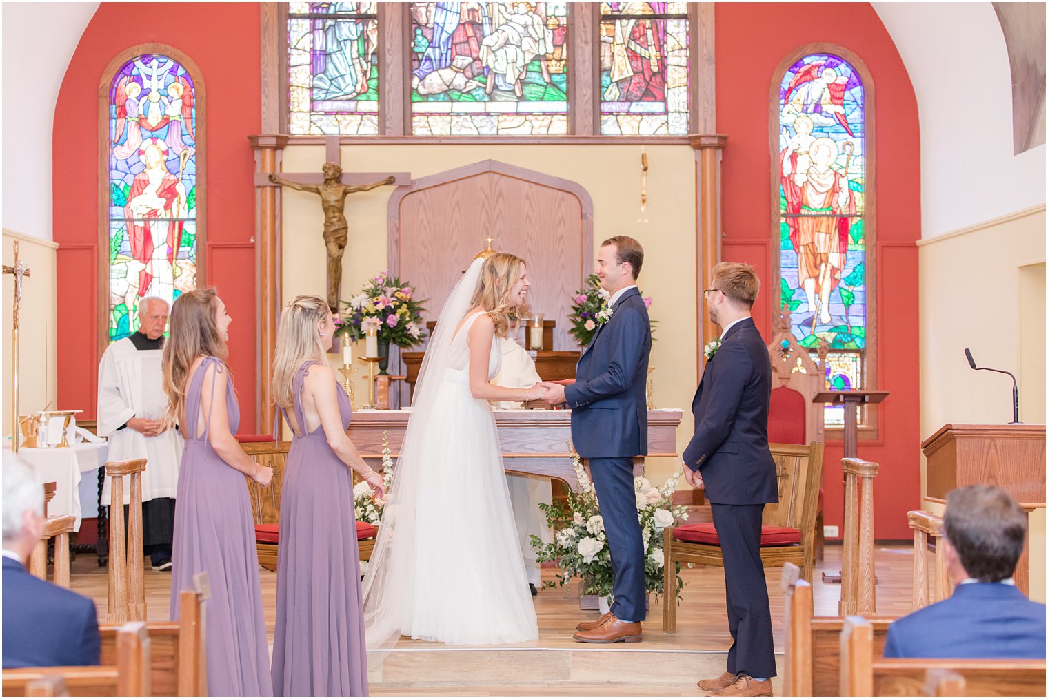 bride laughs during vow renewal in church wedding in New Jersey 