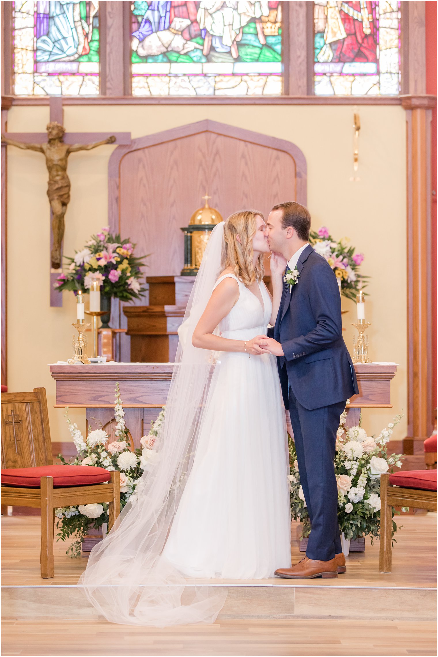 newlyweds kiss during church wedding in New Jersey 