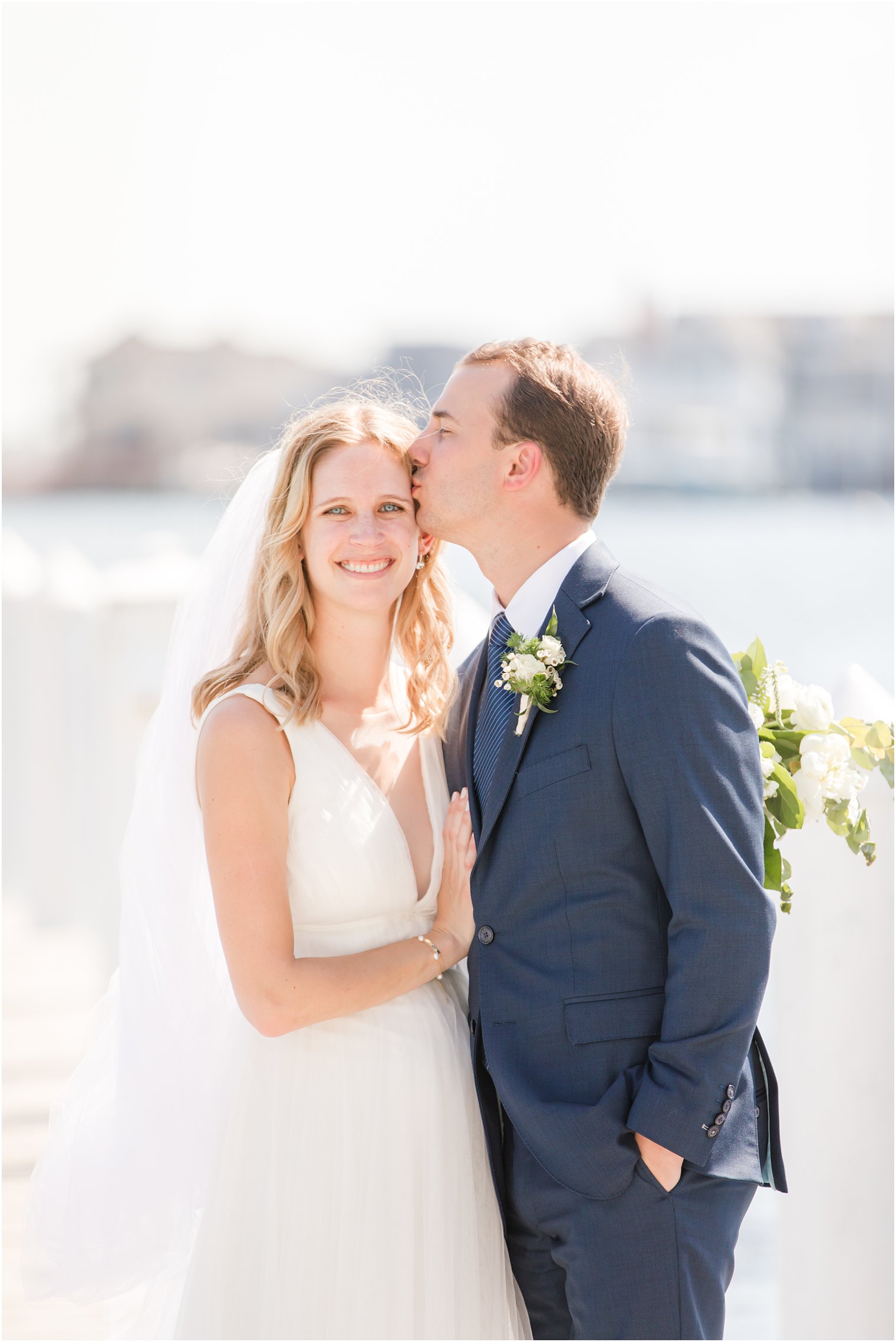 groom kisses bride's forehead during NJ wedding photos in Bay Head 