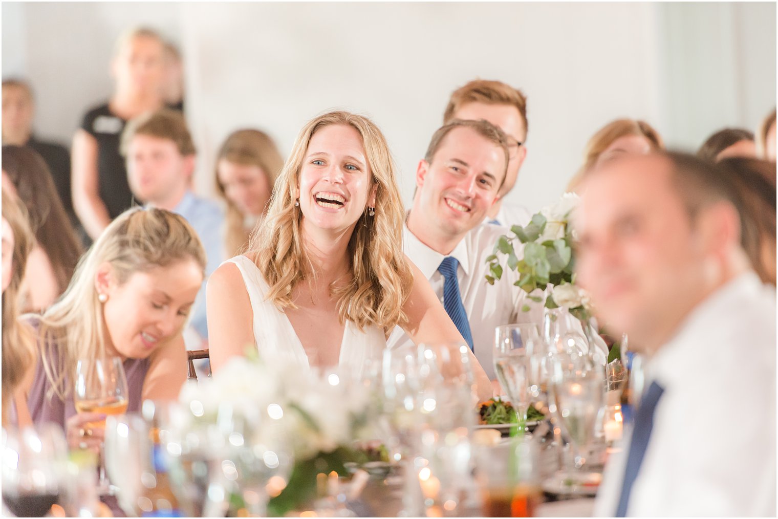 bride laughs during wedding toasts at New Jersey wedding reception 