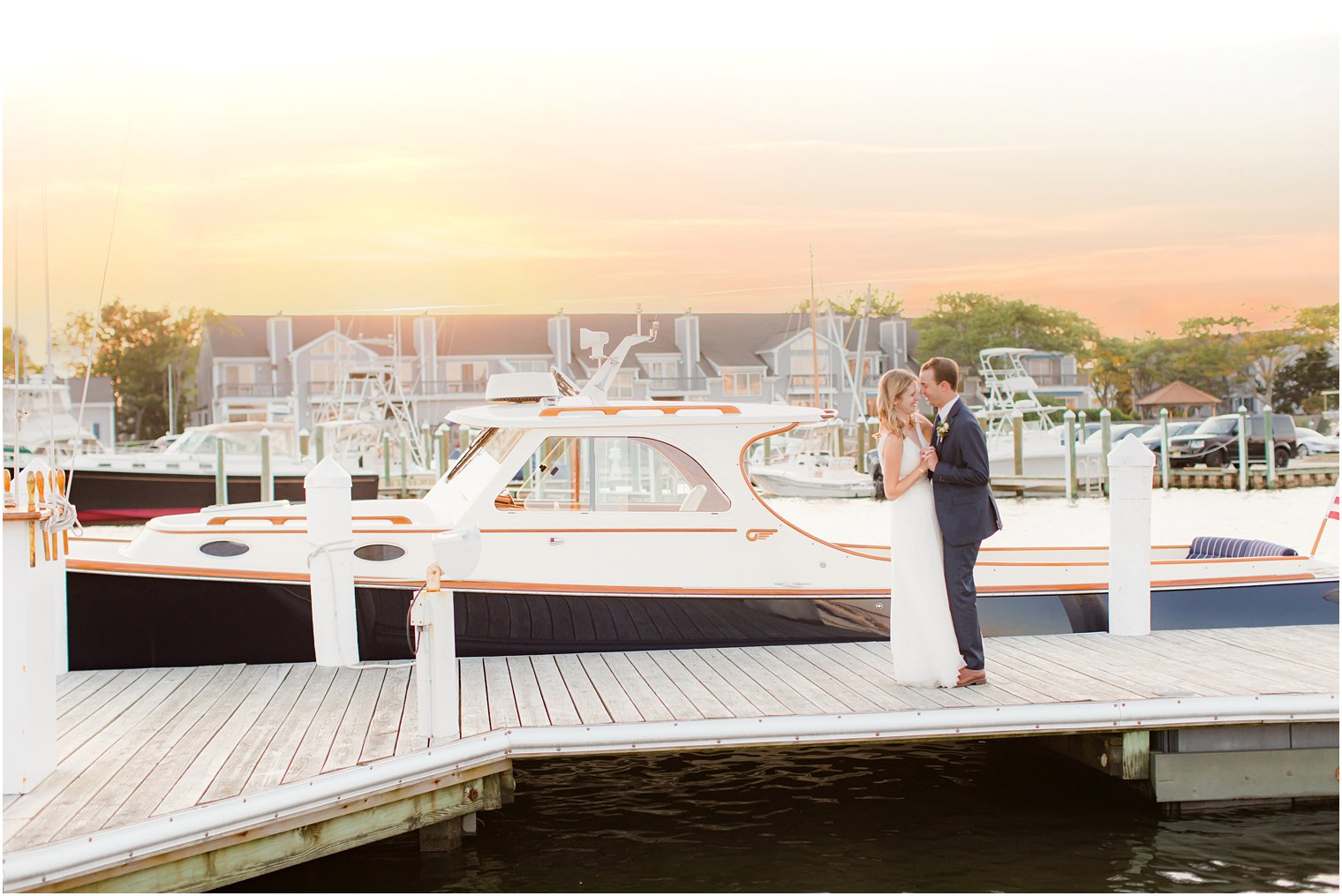 sunset wedding portraits alongside boat at Bay Head Yacht Club