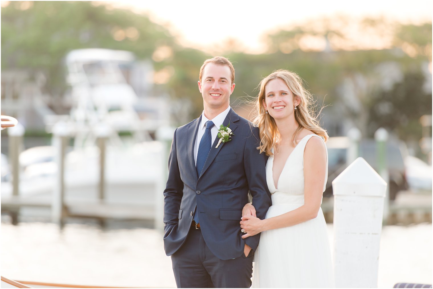 bride and groom hold hands on pier at Bay Head Yacht Club