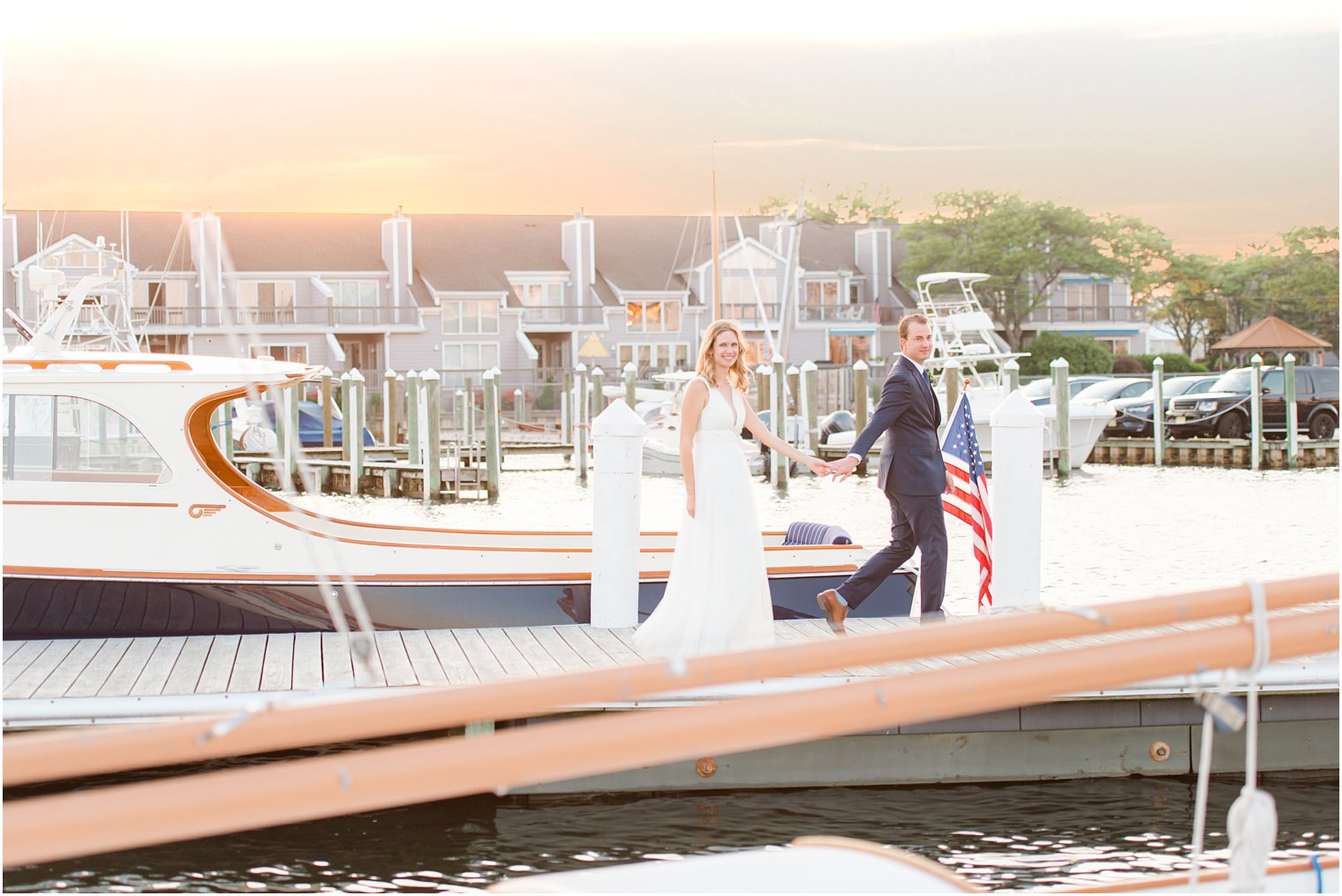 bride and groom walk along pier at Bay Head Yacht Club