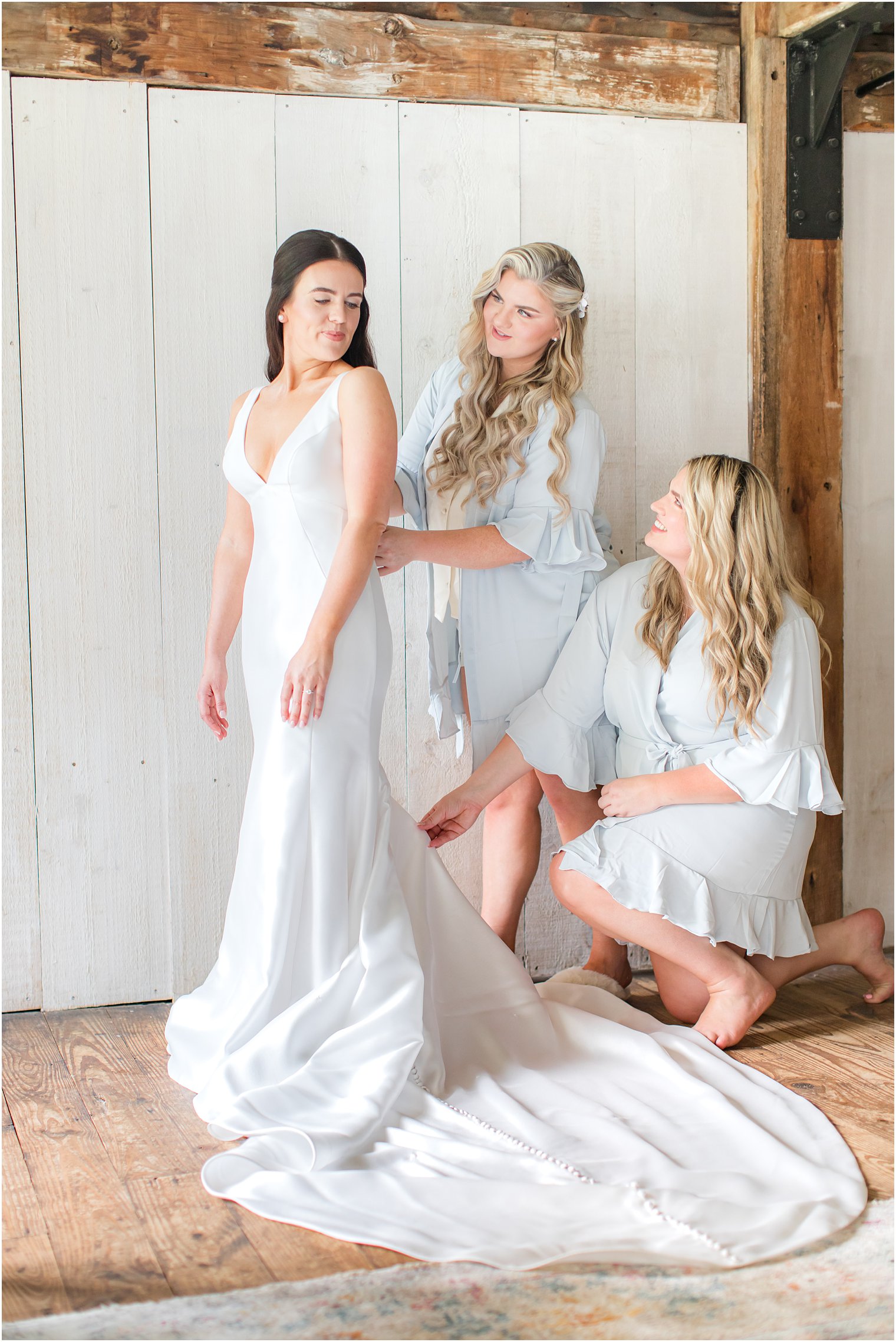 Bride getting dressed in t Crossed Keys Estate wedding bridal suite