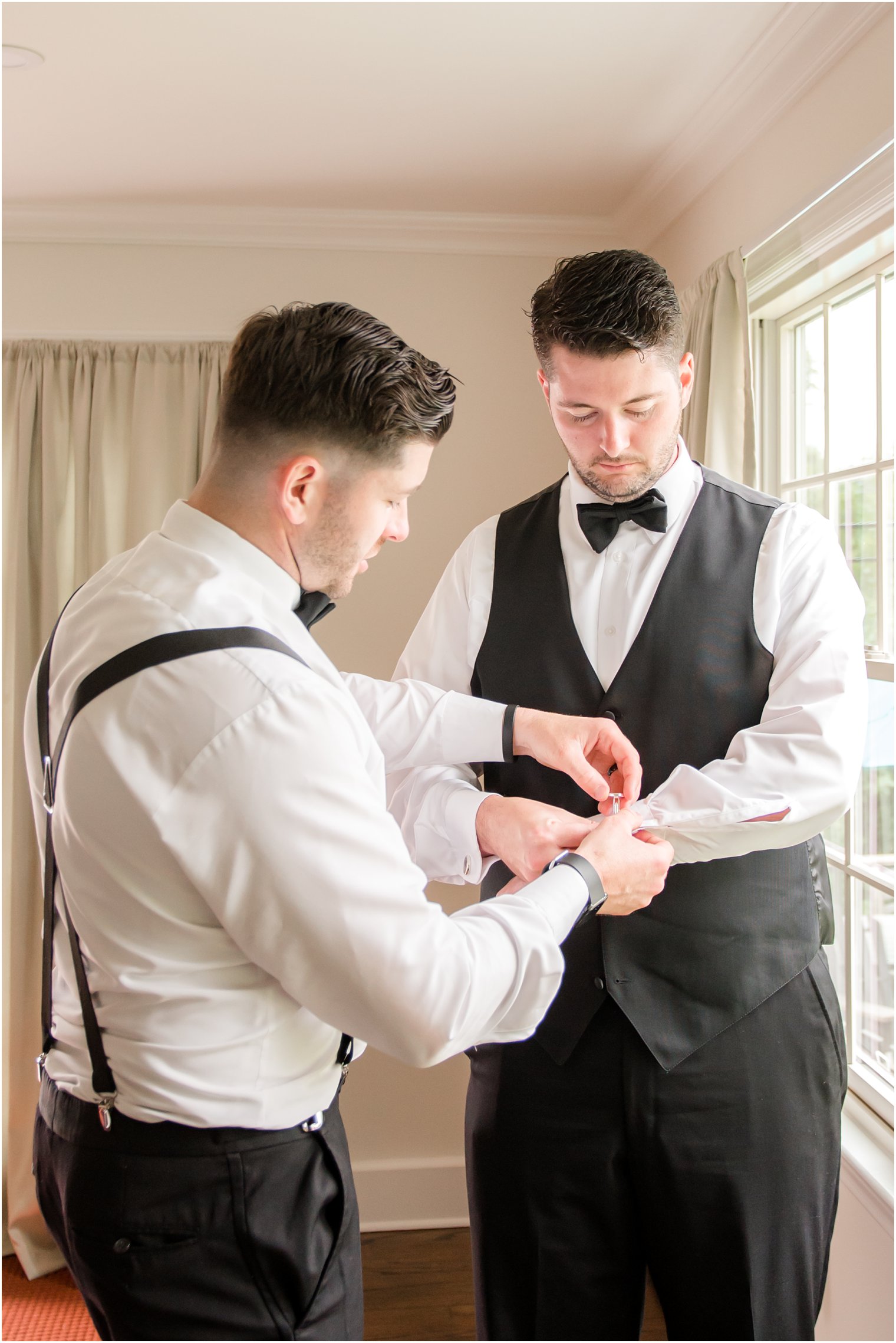groom putting on cufflinks 
