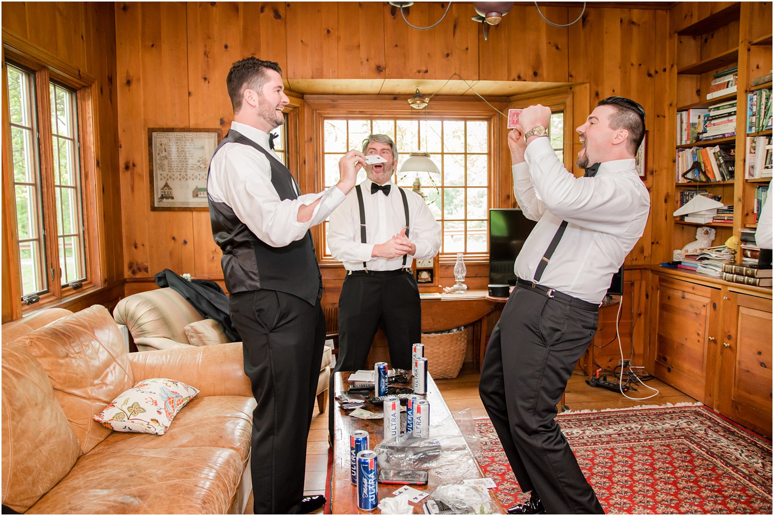 groom playing card game with groomsmen
