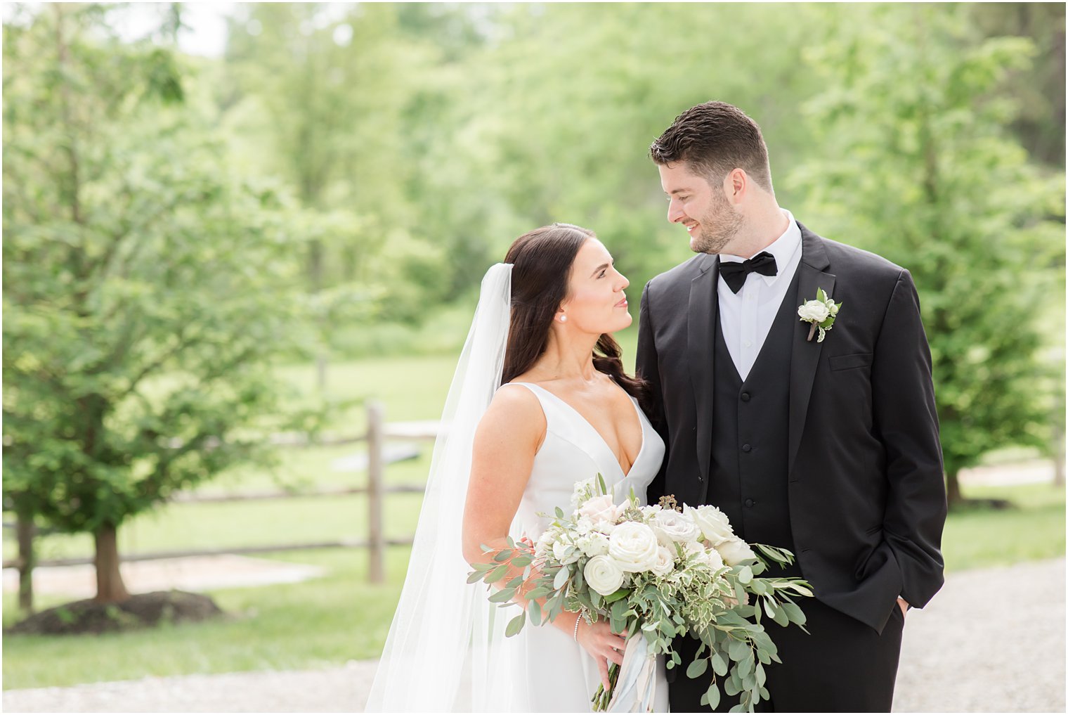 bride and groom smiling at each other during formal portraits