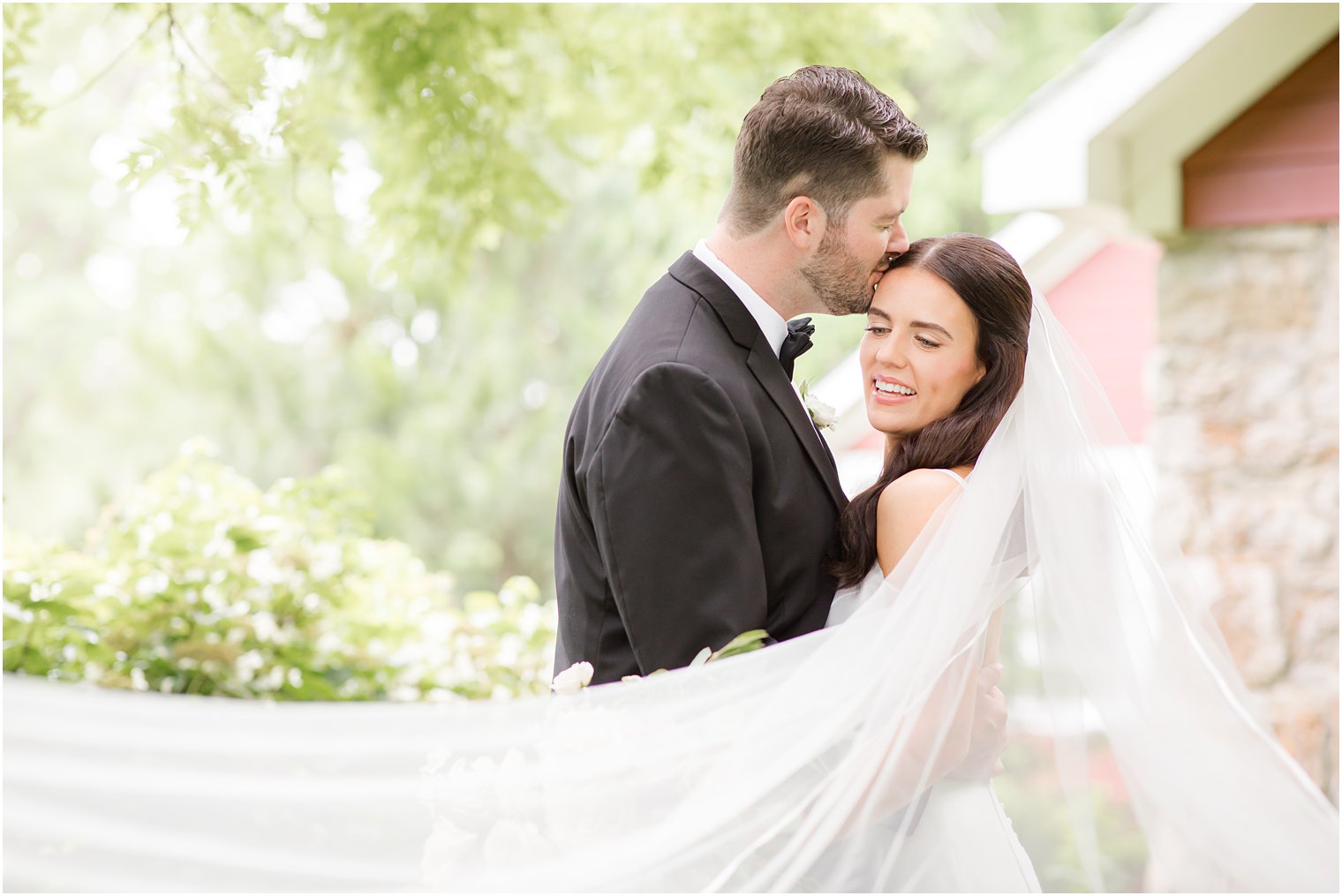 groom kissing bride with veil in foreground | Crossed Keys Estate Wedding Photos