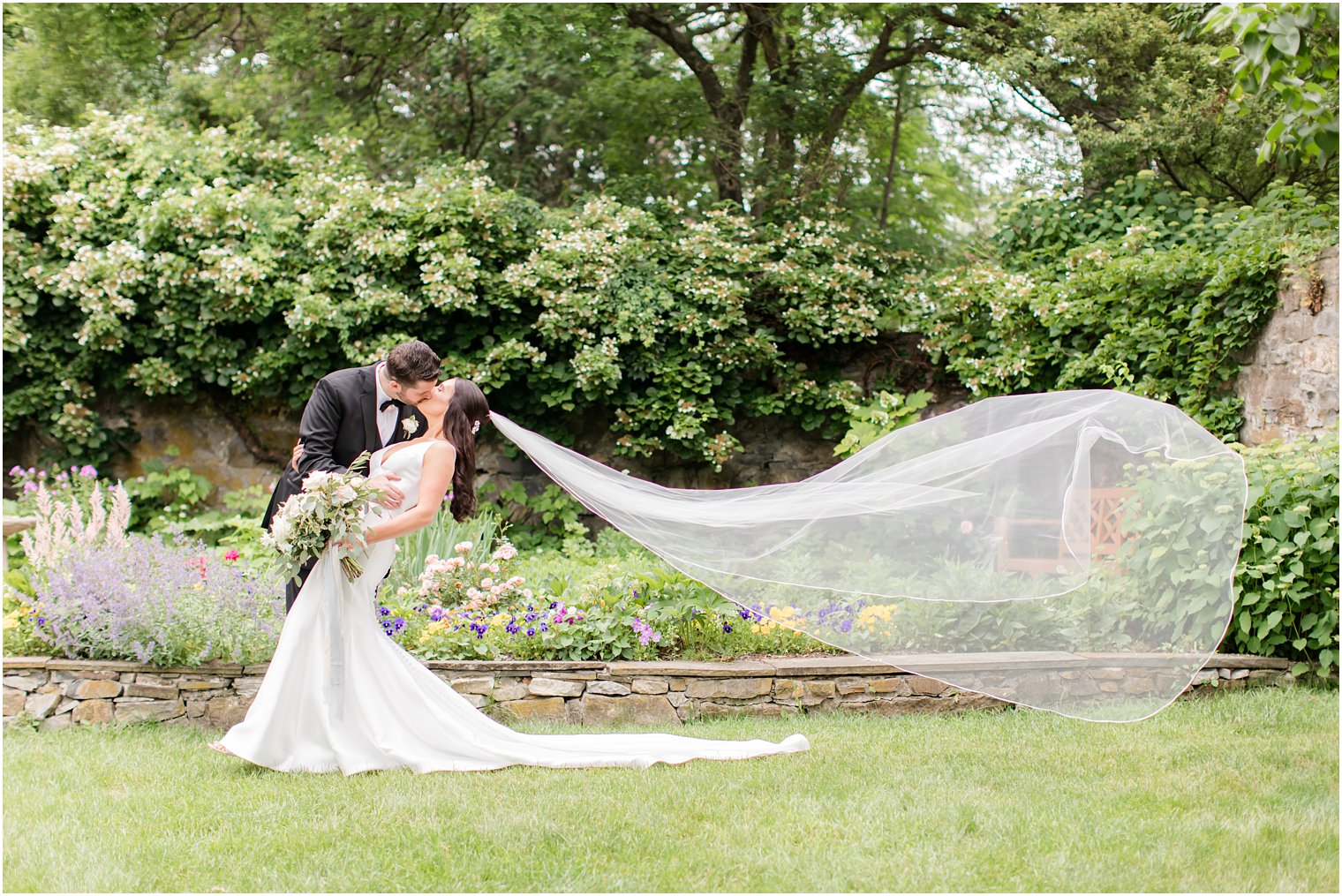 groom kissing bride and dipping her for photos at Crossed Keys Estate wedding