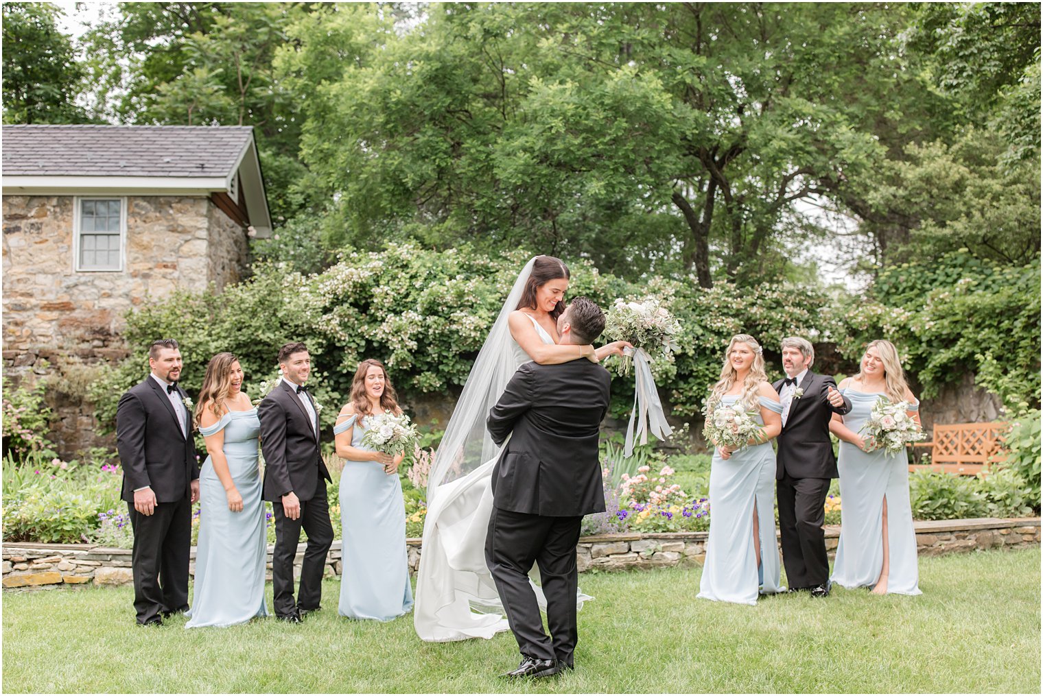 groom lifting bride during bridal party photos at Crossed Keys Estate