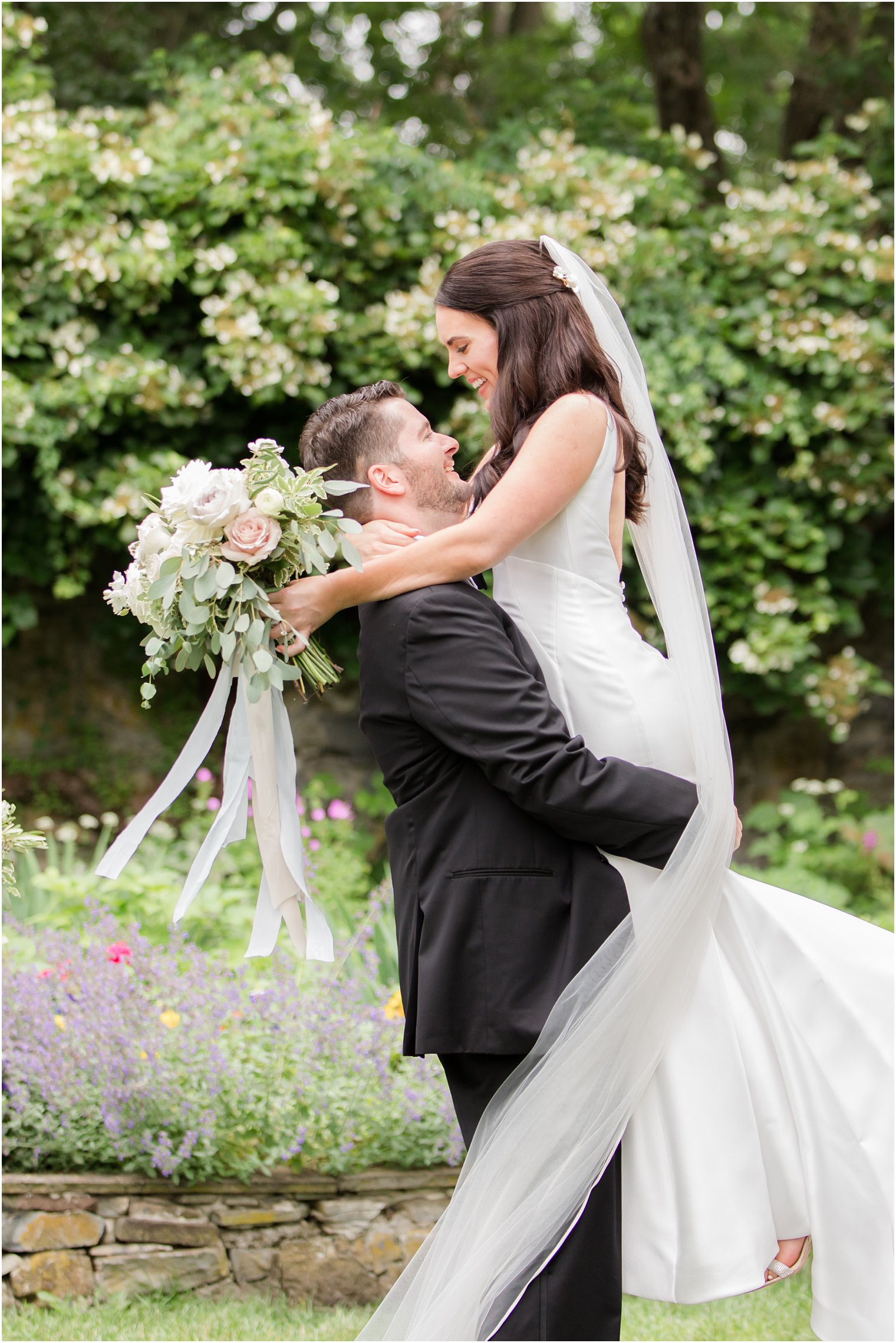 groom lifting bride during photos at Crossed Keys Estate