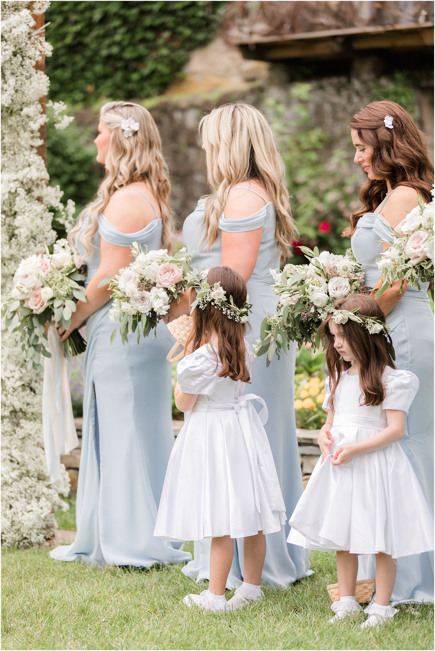 flower girls in flower crowns watching ceremony 