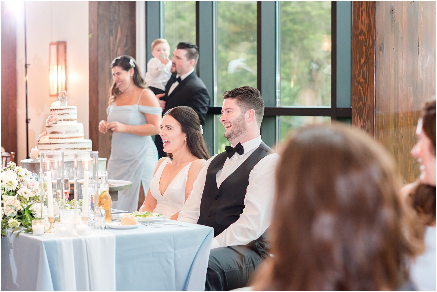 bride and groom laughing during toasts