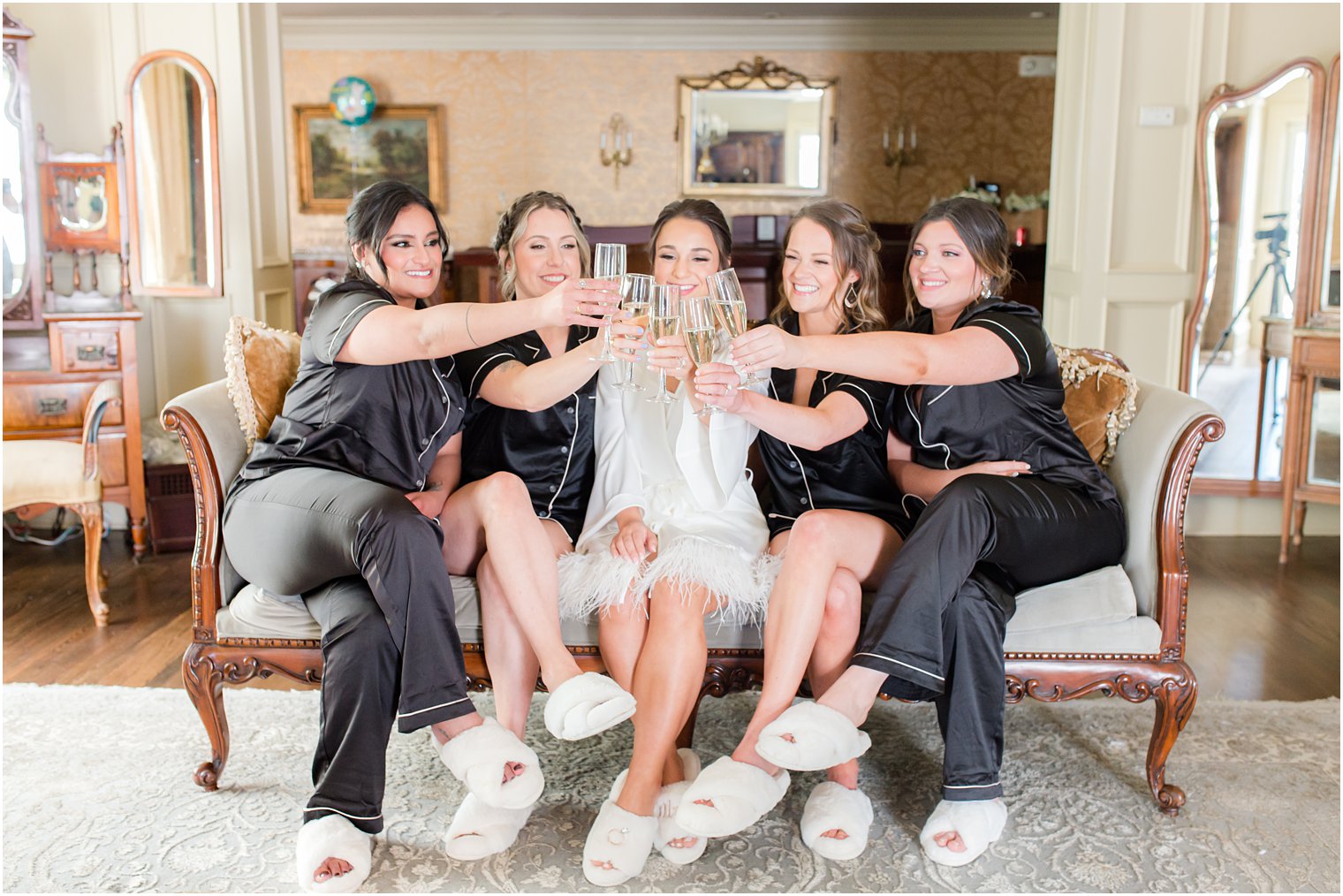 bride and bridesmaids toast champagne before NJ wedding ceremony 