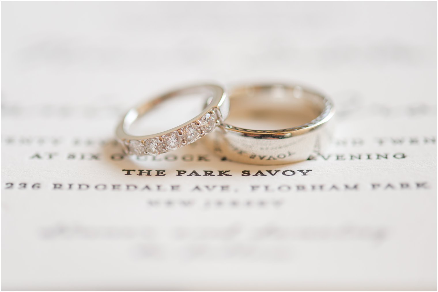 wedding bands rest on wedding invitation for The Park Savoy 