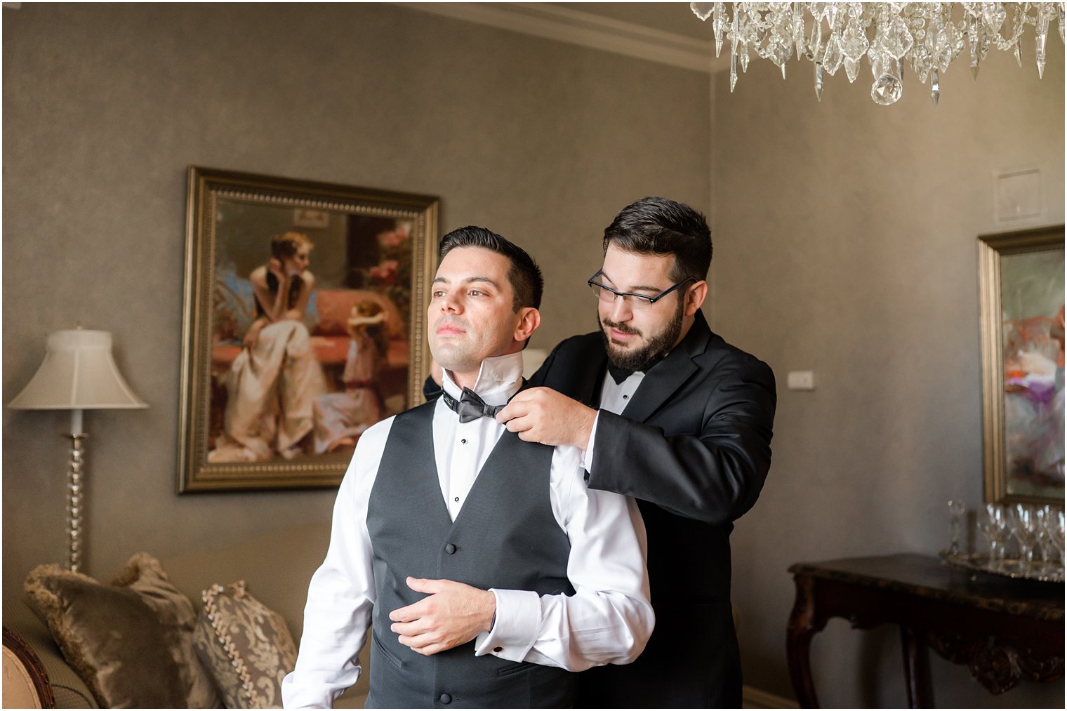 groomsman adjusts bowtie for groom before Park Savoy Estate wedding 