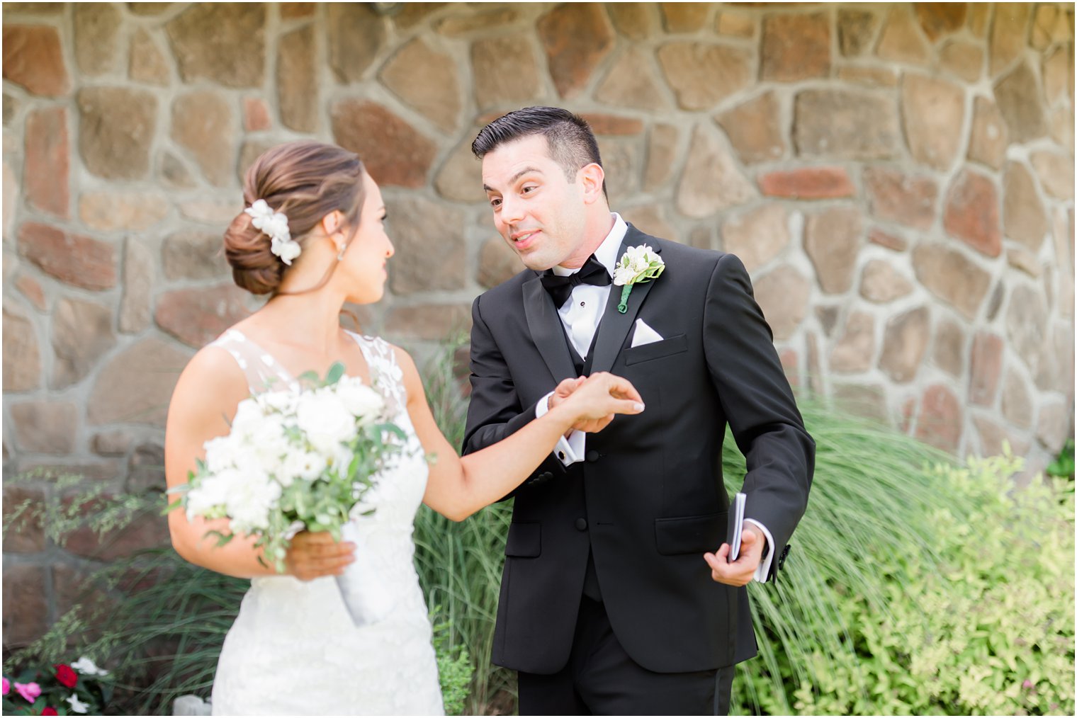 groom smiles while turning bride to see wedding gown 