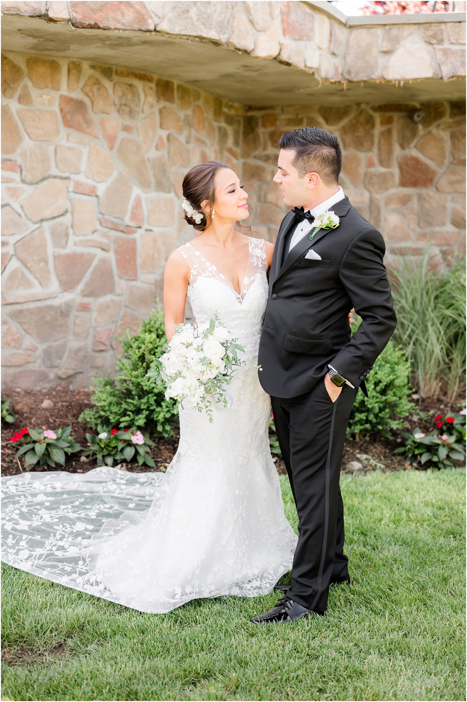 NJ couple smiles at each other by stone balcony at Park Savoy Estate