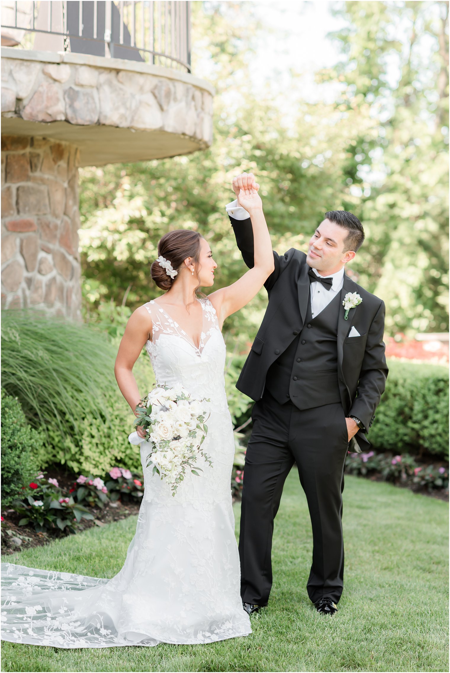 groom twirls bride during wedding photos at Park Savoy Estate