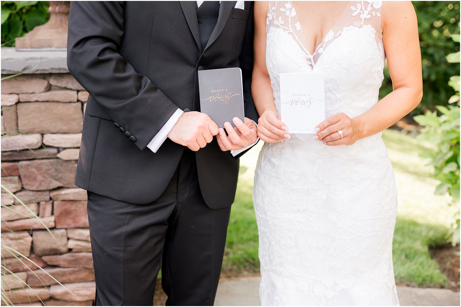 newlyweds hold custom vow booklets before NJ wedding 
