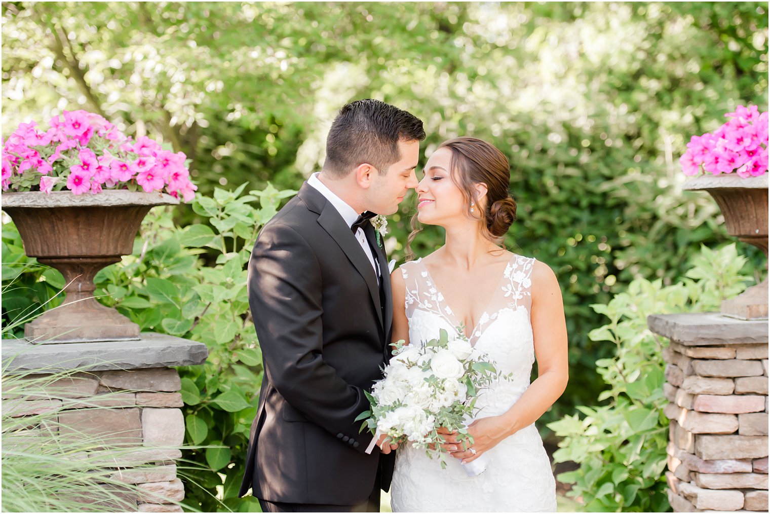 bride and groom touch noses during wedding portraits in gardens of Park Savoy Estate