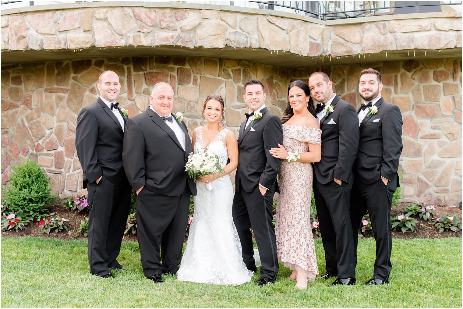 bride and groom pose with family before NJ wedding ceremony 
