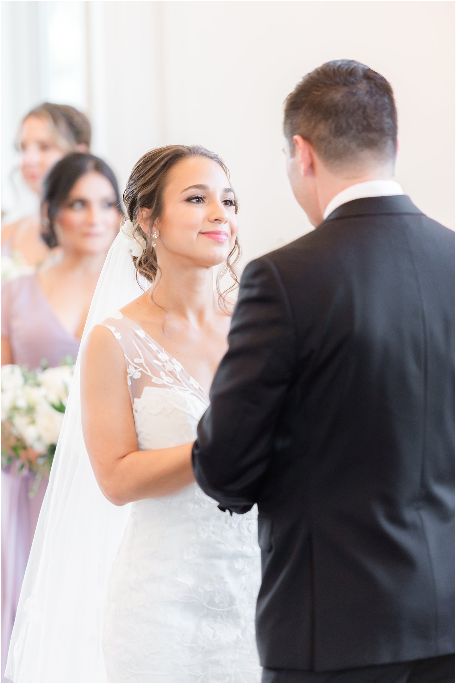 bride looks at groom during vows in chapel 
